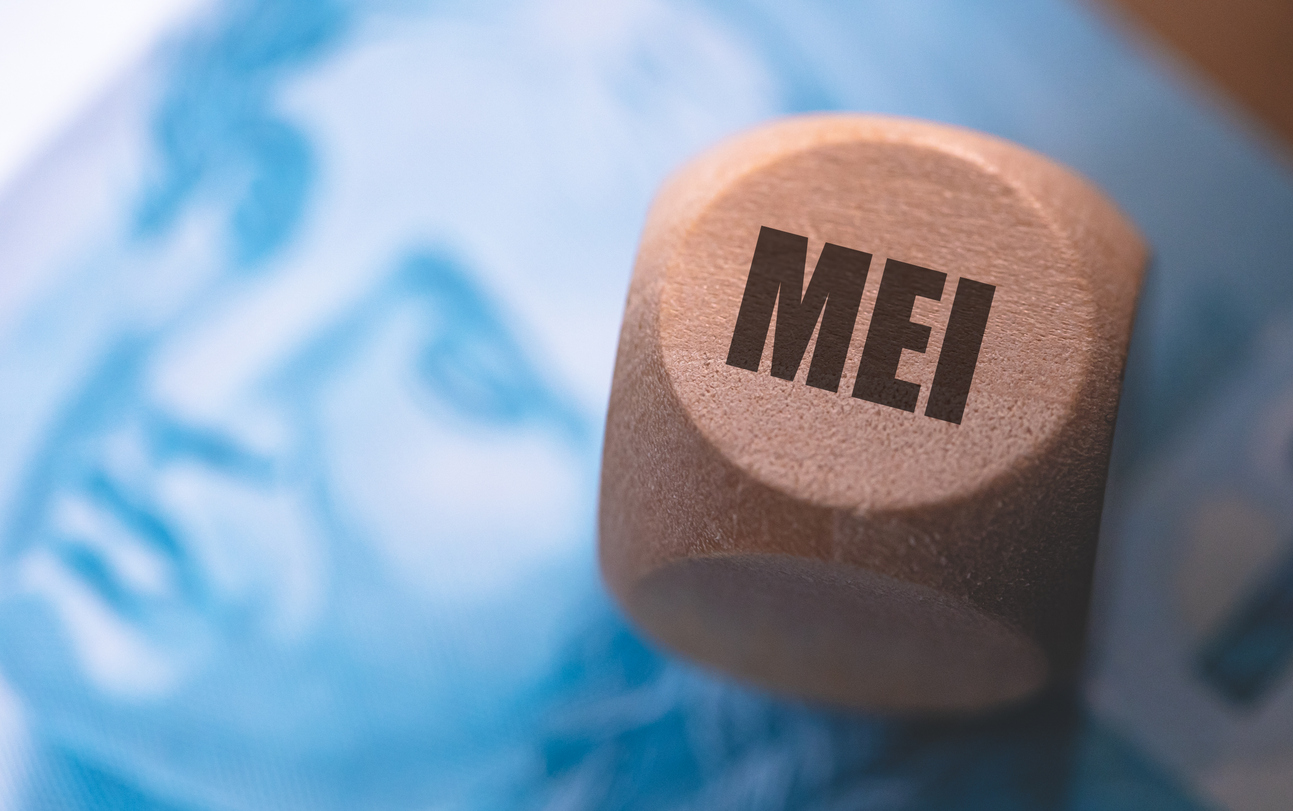 The Acronym Mei For Individual Microentrepreneur In Brazilian Portuguese Written On A Wooden Die. Note Of The Brazilian Real In The Composition.